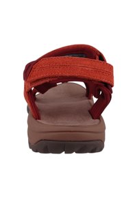 Red and orange suede strap sandals with a brown rubber sole. Features adjustable straps with textured surface for grip and comfort.