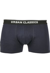 Mørk marineblå bomullsboxere med svart elastisk liv fra Urban Classics med teksten "URBAN CLASSICS" i hvitt. Glatt tekstur, tettsittende design.