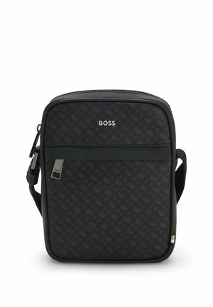 Black crossbody bag with a textured pattern, zip closure, and logo in silver. Features adjustable strap and front pocket detail.