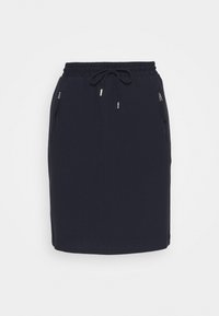 Marinblå kjol med dragsko i midjan, med två fickor med dragkedja och en texturerad tyg. Rakt snitt, knälång design.