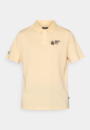 Light yellow polo shirt featuring short sleeves, a three-button placket, and embroidered animal graphics on the chest and sleeve.