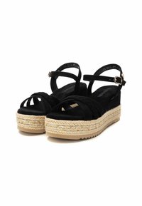 Sandali con zeppa in suede nero e piattaforma in iuta intrecciata, caratterizzati da fasce incrociate e una cinghia alla caviglia regolabile con un sottolineatura in oro.