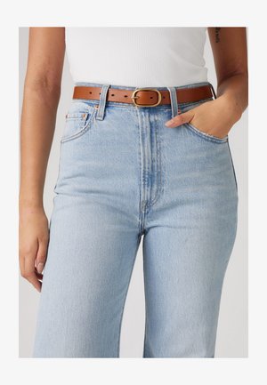 Light blue high-waisted jeans with a straight leg, featuring a brown leather belt with a gold buckle and side pockets.