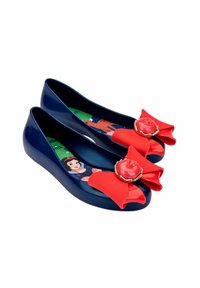 Navy glossy flats with a red bow detail and circular emblem. Interior has a colorful character design. Smooth, rubber-like material.
