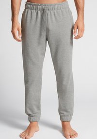 Grijze sweatpants met een elastische tailleband, verstelbaar trekkoord en aansluitende boorden. Gemaakt van zachte stof met een gladde textuur.