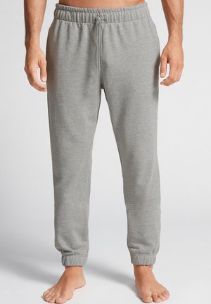Graue Sweatpants mit einem elastischen Bund, verstellbarem Kordelzug und enganliegenden Bündchen. Hergestellt aus weichem Stoff mit glatter Textur.