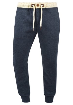 Navy jogger pants made of soft fabric, featuring a cream drawstring, elastic waistband, and ribbed cuffs. Minimalist design with no additional patterns.