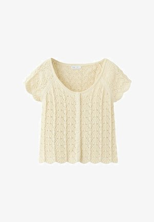 Kremowy krótki kardigan na krótki rękaw z dzianiny, z falistymi krawędziami, zapięciem na guziki z przodu oraz misternym ażurowym wzorem przypominającym liście.