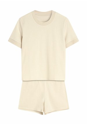 Beżowy zestaw w paski, składający się z krótkiego topu z okrągłym dekoltem oraz pasujących szortów z elastycznym pasem. Miękka faktura tkaniny.