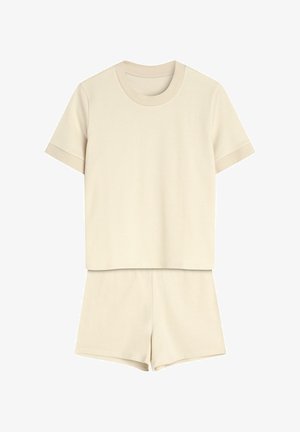 Beżowy zestaw w paski, składający się z krótkiego topu z okrągłym dekoltem oraz pasujących szortów z elastycznym pasem. Miękka faktura tkaniny.