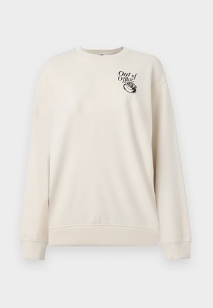 Sweat-shirt à manches longues couleur crème avec poignets et ourlet côtelés, arborant le texte "Out of Office" et un graphique de téléphone vintage sur la poitrine.