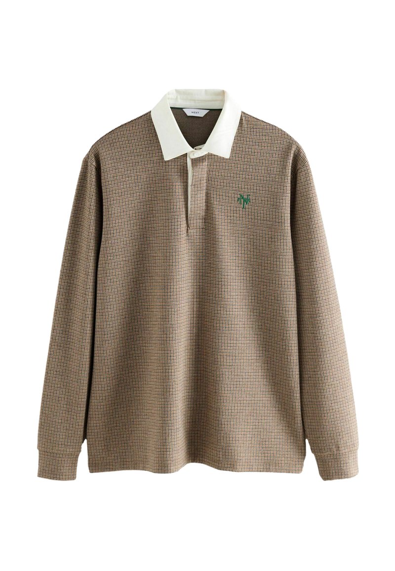 Långärmad pikétröja i brunt och krämfärgat houndstooth-mönster med vit krage och en grön logotyp på bröstet. Mjuk tygstruktur.