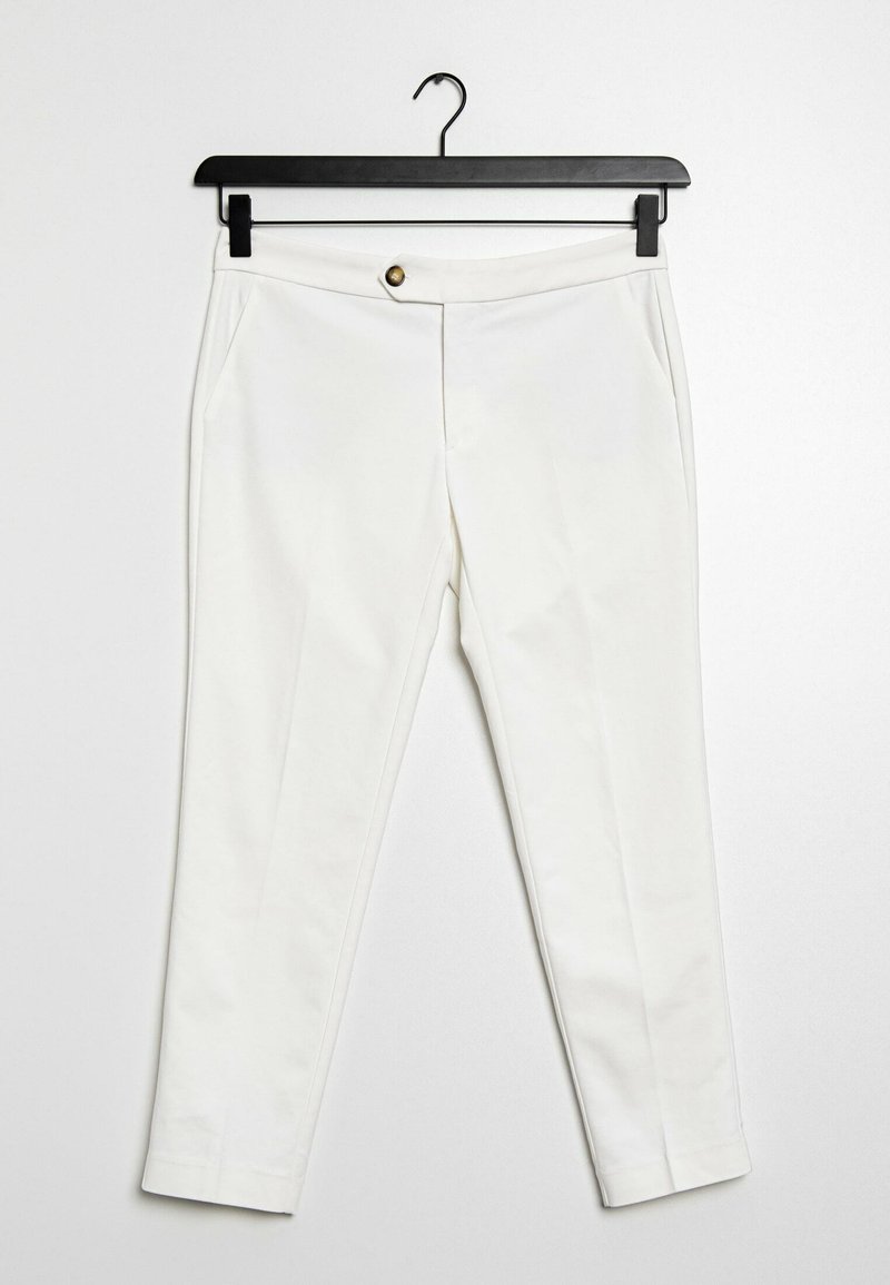 White trousers made of lightweight fabric, featuring a front button closure, two side pockets, and a slim fit design. Hangs on a black hook.