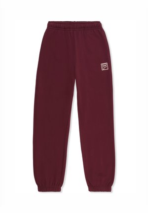 Pantalones de chándal color burdeos con cintura y puños elásticos. Presenta un pequeño logo blanco en el lado izquierdo. Fabricados con material suave y ligero.