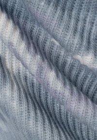 Strickstoff in Blau- und Weißtönen mit schimmernden Akzenten. Strukturiert mit vertikalen Rippen und sanften, verblendeten Farbverläufen.