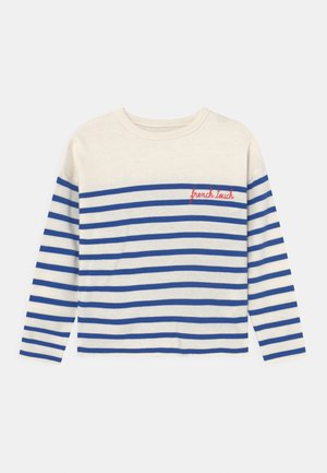 Camisa de manga larga color crema con rayas horizontales azules y bordado rojo "french touch" en la parte superior izquierda del pecho.