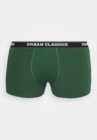 Zöld pamut boxeralsó fekete derékkal, fehér betűkkel a "Urban Classics" felirattal. Simább textúrájú és testhezálló kialakítású, kontúros zacskóval.