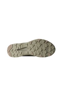 Sko såle med et lysegrønt gummimateriale, en teksturert overflate og multidireksjonale knotter, samt en beige fargeakent langs kanten.
