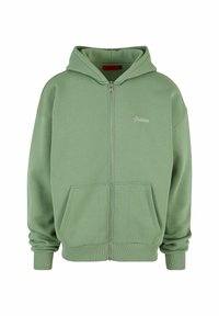 Haut à capuche zippé vert en matériau doux. Comprend une capuche, des poches avant et des poignets côtelés. Petit logo "Interdit" près du zip.