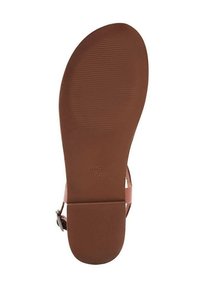 Suola in gomma marrone con grip testurizzato. Presenta un design minimalista e un logo impresso. Superficie liscia e forma arrotondata.