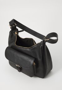 Black leather shoulder bag with gold hardware, zip closure, and a front flap pocket. Features a single adjustable strap. Smooth texture.