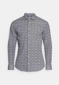 Dlouhý rukáv, košilový top s černobílým květinovým vzorem. Disponuje klasickým límcem a manžetami, vyrobený z lehké látky.