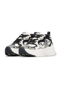 Sneaker chunky bianchi, neri e grigi con suole spesse, lacci neri e accenti a forma di stella sui lati, mostrati da un'angolazione frontale.