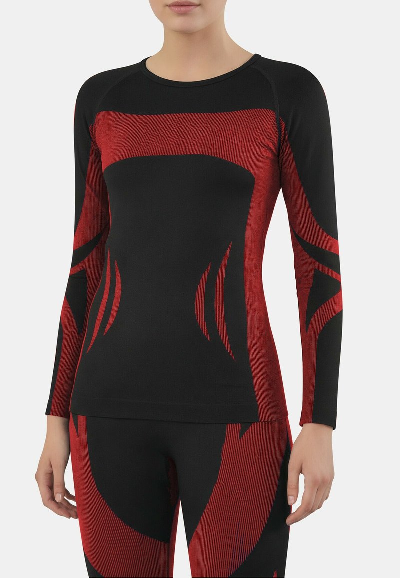 Long-sleeve athletic top in black with red graphic lines. Fabric appears stretchy, featuring a fitted design and textured accents.
