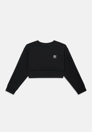 Hanorac negru Adidas crop cu mâneci lungi și un mic logo alb trefoil pe pieptul stâng, expus pe un fundal gri deschis.