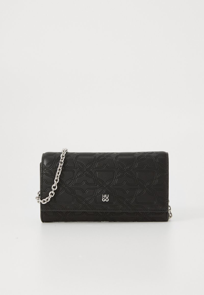 Black textured leather clutch with embossed patterns, silver "HUGO" logo, and a silver chain strap against a white background.