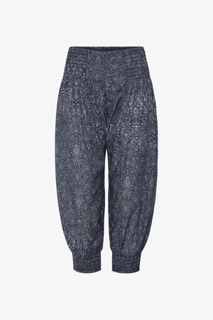 Dark blue capri pants with white intricate paisley pattern, elastic waistband, and elastic cuffs at the ankles.
