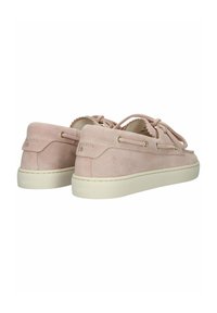 Light pink suede boat shoes with white rubber soles, lace details, and padded collar, viewed from the back and angled side.