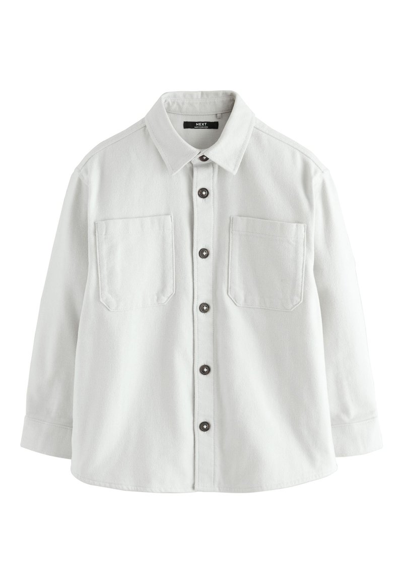 White button-up shirt made of a soft fabric, featuring two chest pockets, a classic collar, and brown buttons on the front.