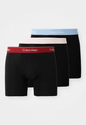 Schwarze Boxershorts mit elastischem Bund in Rot, Hellblau und Pink mit "Calvin Klein"-Logo. Glattes Material mit einer enganliegenden Passform.