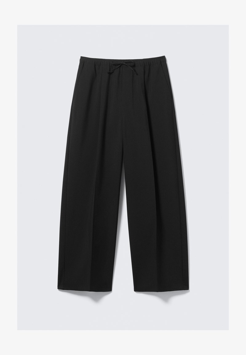 Pantalons larges noirs en tissu léger, avec une taille élastique et un cordon de serrage, sans poches visibles.