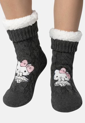 Dark gray knitted socks with white fleece cuffs, featuring a white cat face with a pink bow on each sock, worn on bare legs.