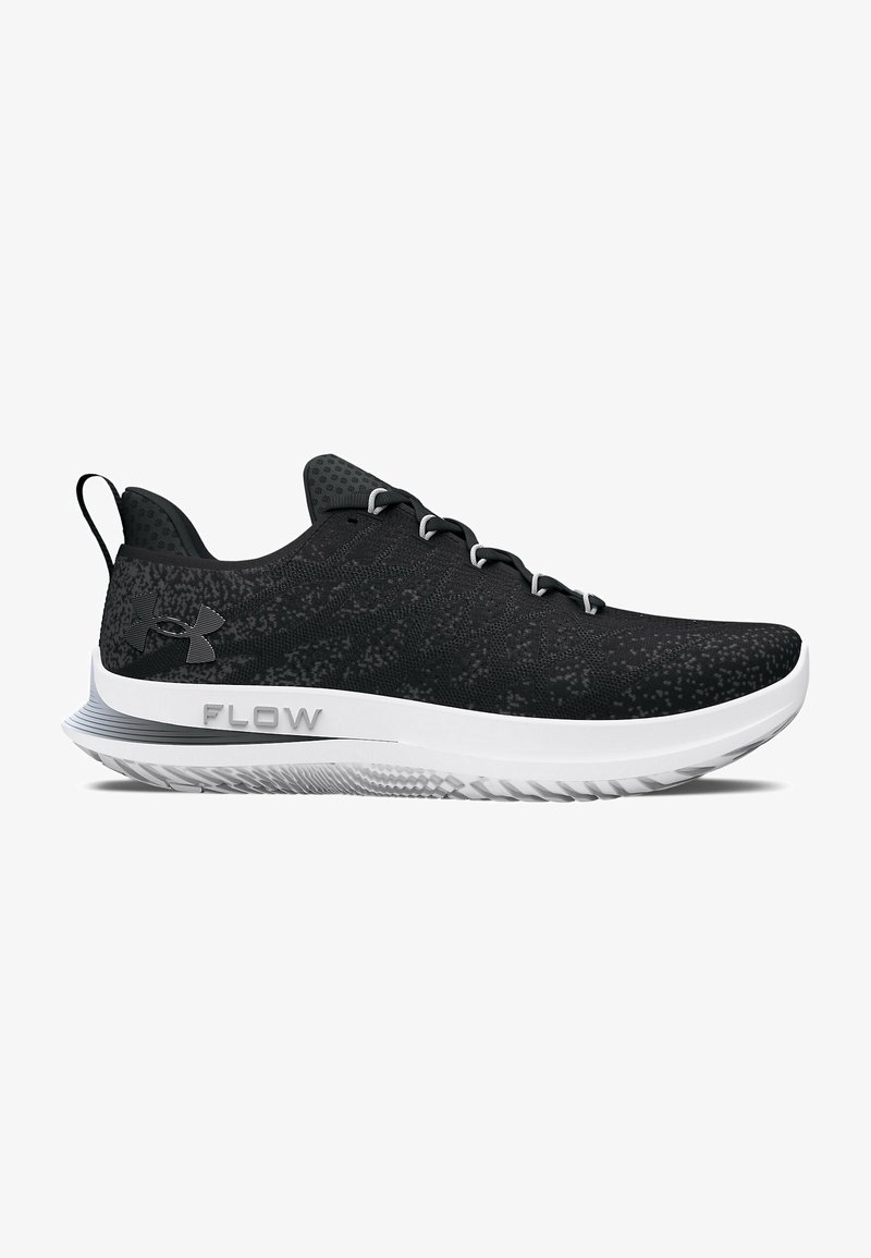 Black athletic shoes with textured mesh upper, white sole, and grey accents. Features a logo and the word "FLOW" on the side. Lightweight design.