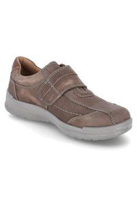 Brown leather shoe with a Velcro strap, rubber sole, and white stitching accents. Rounded toe and cushioned insole for comfort.