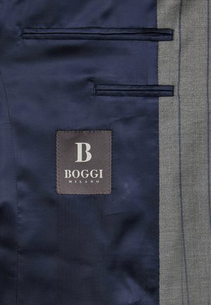 Navy satin fabric with grey striped wool panel; features two pockets and a label reading "BOGGI MILANO" in white on a dark background.