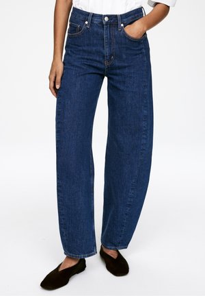 Dark blue denim wide-leg jeans with a high waist, five-pocket design, and contrast stitching. The fabric has a smooth texture.
