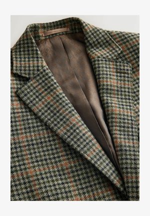 Wool blazer featuring a green, black, and orange houndstooth pattern, with a smooth brown satin interior and notch lapels.