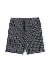 Pantaloni corti bianchi e neri con un design geometrico, vita elastica e coulisse, realizzati in tessuto leggero.
