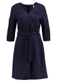 Námořnické šaty do zavinování, lehká tkanina, výstřih do V, dlouhé rukávy s detailním knoflíkem, pas se zavazováním a délka po kolena. Hladká textura, jednobarevný.