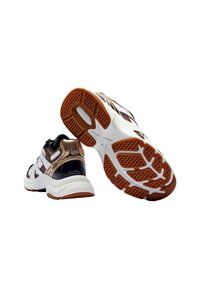 Sneakers sportivi con un design nero, bianco e oro metallizzato. Suola in gomma testurizzata con un motivo di battistrada marrone. Sottopiede imbottito bianco.