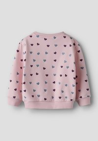 Felpa rosa chiaro con motivo di piccoli cuori viola scuro e blu metallizzato. Polsini e orlo a coste, tessuto morbido al tatto.