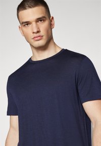 Navy blue short-sleeve t-shirt made from soft fabric. Features a round neckline and a smooth, textured finish with no visible patterns.