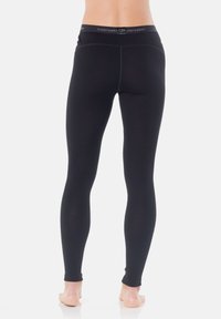 Svarta leggings med hög midja och tonad sömnad. Gjorda av ett slätt, stretchigt tyg, lämpliga för att lager på lager eller för aktivt bruk.