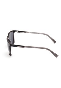 Ochelari de soare sport cu o ramă ușoară de culoare neagră, lentile fumurii și un design curbat. Caracteristicile includ accente texturate pe brațe.