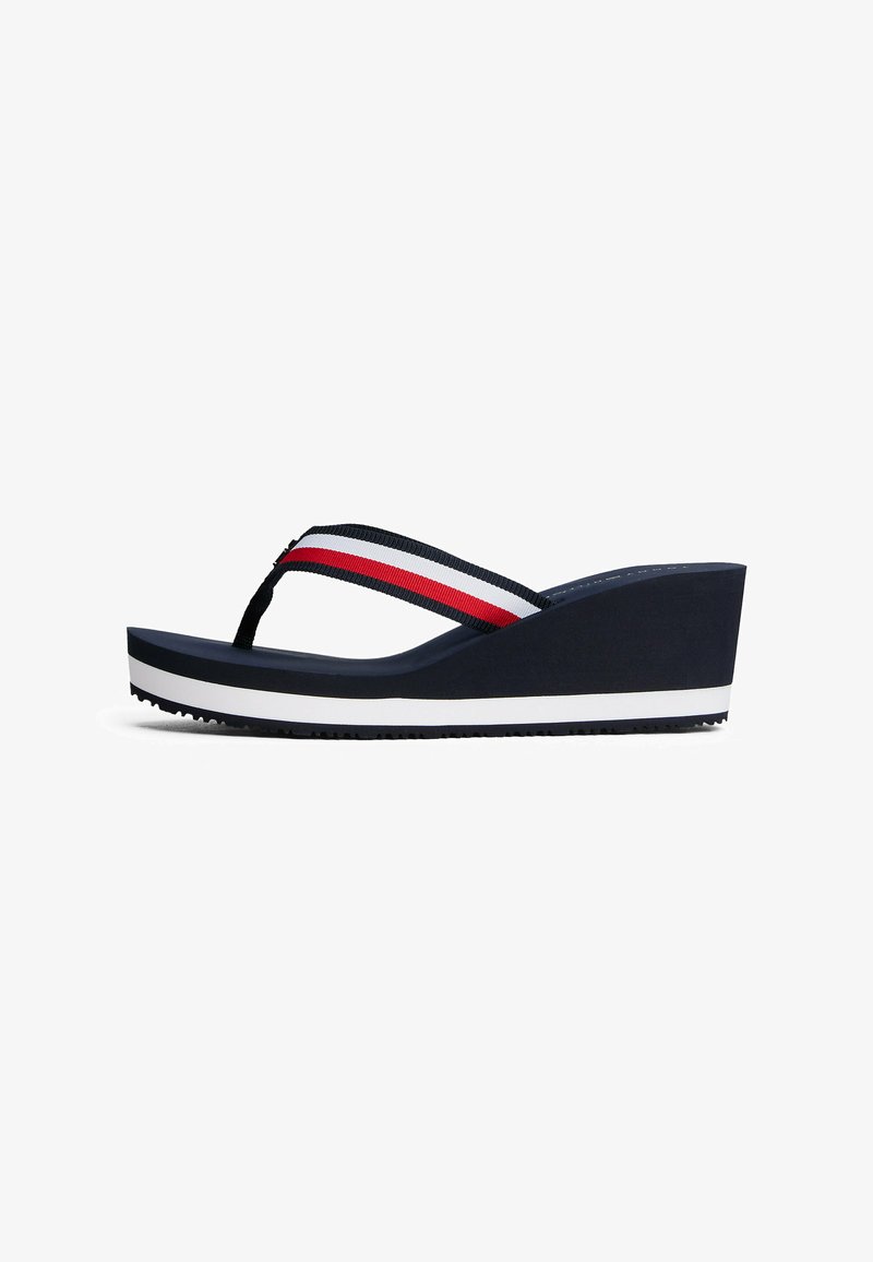 Navy wedge flip-flop made of rubber, featuring a dual-striped fabric strap in red and white, with a white stripe base and textured sole.