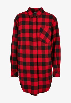 Punase ja musta ruuduline flanellpaita, millel on nööbid ees, terav krae ja üks rinna-tasku. Pika varrukaga, nööbitud mansetid.